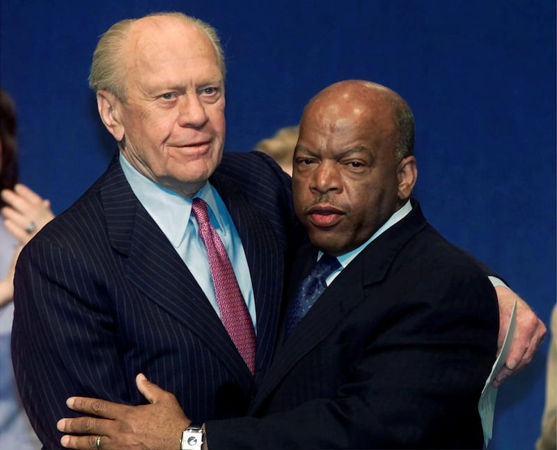 Former US President Gerald Ford hugs US Congressman John Lewis after the two men received John F. Kennedy Profile in Courage awards May 21, 2001 at the JFK Presidential Library in Boston. Reuters