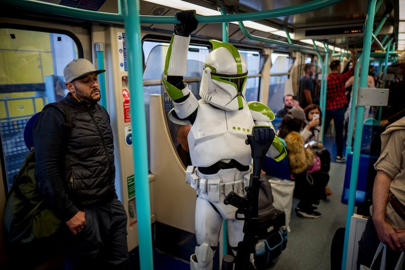 A cosplayer dressed as a Clone Trooper from Star Wars travel on a DLR train after attending MCM Comic Con in costumes at ExCeL London in London, Britain, 28 October 2022.  MCM Comic Con runs from 28 to 30 October with thousands of cosplayers and film, video games and anime fans attending, as every year.   EPA / TOLGA AKMEN