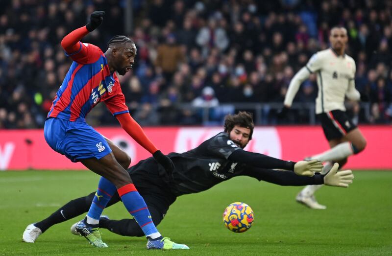 Liverpool goalkeeper Alisson Becker throws himself in front of a shot from Palace's Jean-Philippe Mateta. AFP