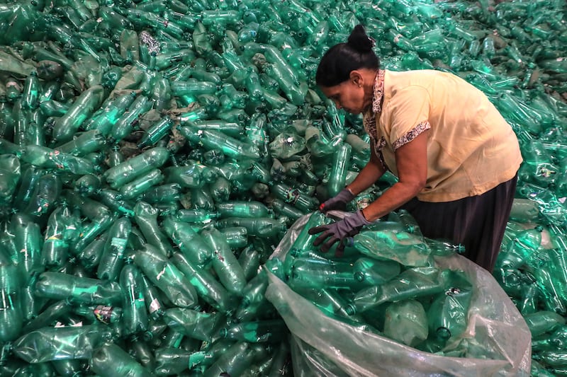 A female labourer sorts out recyclable polyethylene terephthalate, or PET, plastic bottles in the Viridis Recycling Centre in Colombo, Sri Lanka.  EPA 
