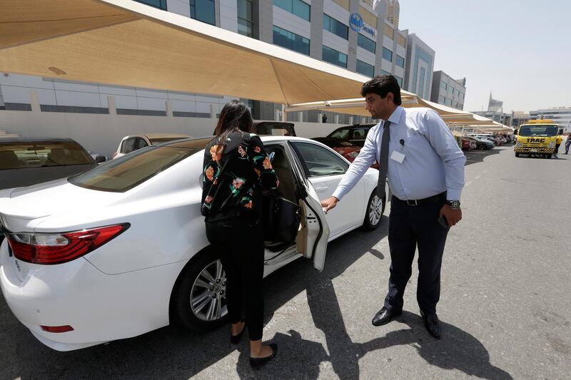 Dubai, United Arab Emirates - August 25, 2016.  Sharan Sunner ( Account Manager - House of Comms ) tries out the Uber taxi service, as she is assisted by Waleed Nawaz Chattha ( Driver - Uber ).  The service is purely dependent on internet transaction when booking a taxi.  ( Jeffrey E Biteng / The National )  Editor's Note;  ID 28976  Sharan Sunner agrees to act like a customer. *** Local Caption ***  JB250816-Uber02.jpg