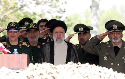 Iranian President Ebrahim Raisi, centre, flanked by Islamic Revolutionary Guard Corps and army generals, attends annual Army Day celebrations at a military base in Tehran on Wednesday April 17, 2024. EPA