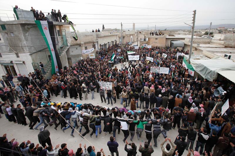 Anti-Syrian regime protesters hold a demonstration in Idlib, Syria, Monday, Feb. 6, 2012. The U.S. closed its Syrian embassy Monday and Britain recalled its ambassador to Damascus in a dramatic escalation of Western pressure on President Bashar Assad to give up power, just days after diplomatic efforts at the United Nations to end the crisis collapsed. (AP Photo) *** Local Caption ***  Mideast Syria.JPEG-02746.jpg