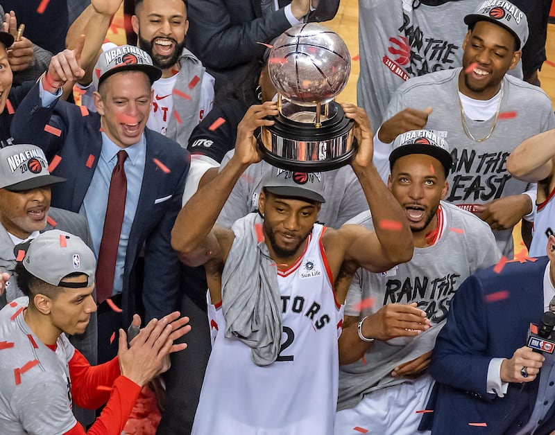 epa07601164 Toronto Raptors forward Kawhi Leonard holds the NBA Eastern Conference Championship trophy. EPA