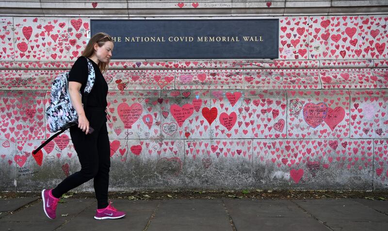 A member of the public walks past the Covid-19 Memorial Wall in London. EPA