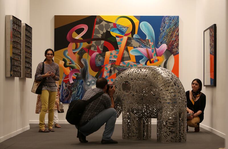 DUBAI , UNITED ARAB EMIRATES Ð  Mar 21 , 2014 : Visitors looking art work in the Art Dubai 2014 at Madinat Jumeirah in Dubai. ( Pawan Singh / The National ) For Arts & Life. Story by Anna Seaman
