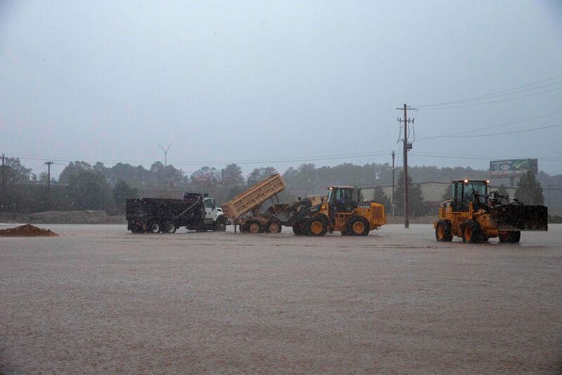 Workers scramble to build a temporary dam to stop rising flood waters from Hurricane Florence in Lumberton, North Carolina. AFP