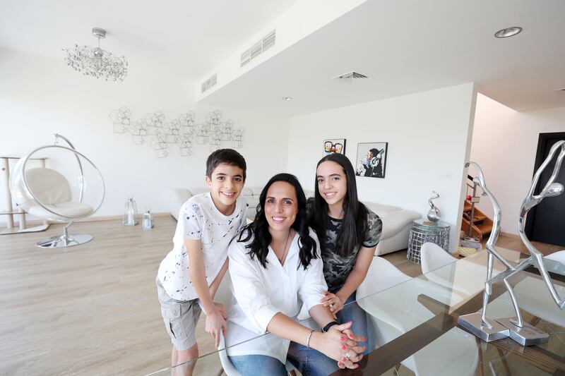 Adam with his mother, Soha El Halfawi, and sister Laila at their home in Arabian Ranches. Ruel Pableo / The National