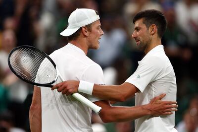 Serbia's Novak Djokovic, right, with the Netherlands' Tim van Rijthoven after their match at Wimbledon on Sunday. AFP