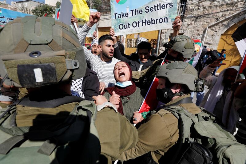 A Palestinian woman shouts slogans in front of Israeli troops during a protest against Israeli settlers, in Hebron, in the Israeli-occupied West Bank. Reuters