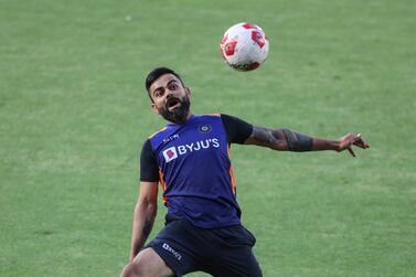 India's Virat Kohli warms up with a soccer ball a training session ahead of the first Twenty20 cricket match between India and England in Ahmedabad, India, Monday, March 8, 2021. (AP Photo/Aijaz Rahi)
