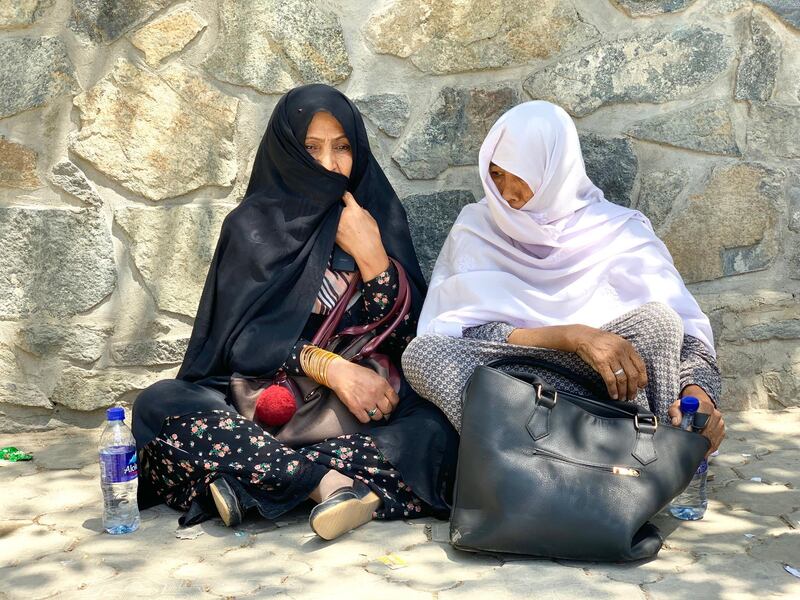 Afghans look for the names of their relatives and friends outside the emergency trauma hospital in Kabul. An ISIS suicide bomber detonated himself in a crowded wedding hall in the Afghan capital on Saturday night, killing 63 and injuring 180 guests. Hikmat Noori for The National