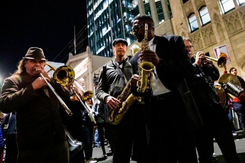 Musicians in a brass band play music along Bush Street during a demonstration in part of a national impeachment rally, at the Federal Building in San Francisco, California. AFP