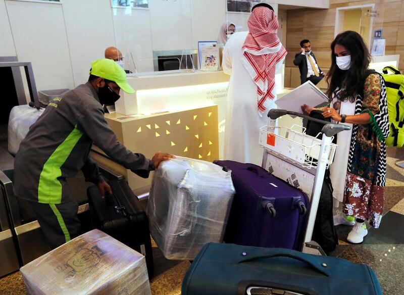 Saudi passenger Hanan Yousef, 35, checks in ahead of a long-awaited trip to Egypt after the travel ban, imposed last year to contain coronavirus infections, was finally lifted in the kingdom. AP Photo