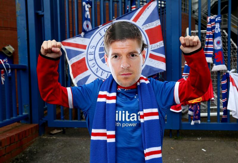 A Rangers fan wears a Steven Gerrard mask outside of the Ibrox Stadium.