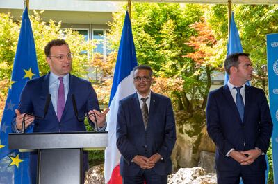 Germany's Minister of Health Jens Spahn, left, next to Tedros Adhanom Ghebreyesus, center, Director General of the World Health Organization (WHO), and France's Minister of Health and Solidarity Olivier Veran, right, speaks to the media, during a press conference, at the World Health Organization (WHO) headquarters in Geneva, Switzerland, Thursday, June 25, 2020. (Salvatore Di Nolfi/Keystone via AP)