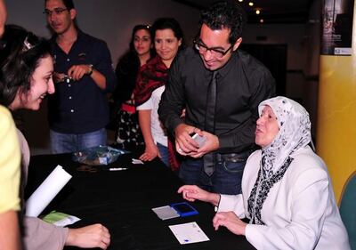 Teta Fatima signing postcards at the film's premiere in 2010. Mahmoud Kaabour