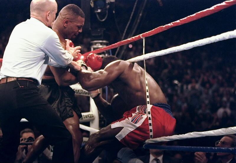 LAS VEGAS - MARCH 16:  (FILE PHOTO) Mike Tyson lands punches to Frank Bruno of Great Britain backing him in the ropes as referee Mills Lane steps in to stop the fight during the third round of the WBC Heavyweight Chamnpionship bout at the MGM Grand Garden on March 16, 1996 in Las Vegas, Nevada.  On September 22, 2003, the former world heavyweight boxing champion was taken to psychiatric hospital for treatment.  It has been reported that Bruno was seeking help for depression as he struggled to come to terms with life outside the ring and a divorce.  (Photo by Al Bello/Getty Images)  