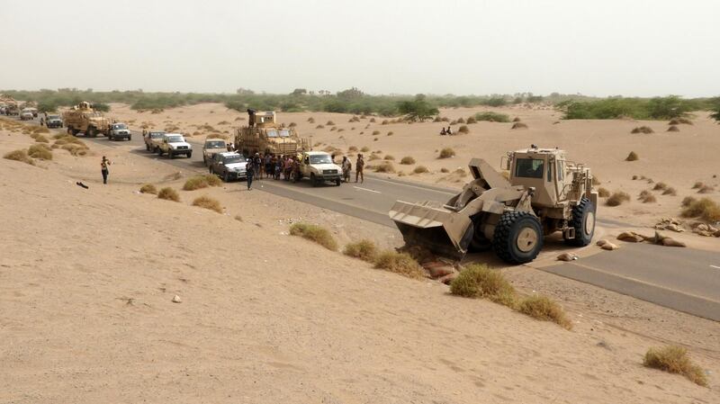 A bulldozer clears the way for a column of Yemeni pro-government forces arriving in al-Durayhimi district, about nine kilometres south of Hodeidah international airport on June 13, 2018. Yemeni forces backed by the Saudi-led coalition launched an offensive on June 13 to retake the rebel-held Red Sea port city of Hodeida, pressing toward the airport south of the city.
The port serves as the entry point for 70 percent of the impoverished country's imports as it teeters on the brink of famine. / AFP / NABIL HASSAN
