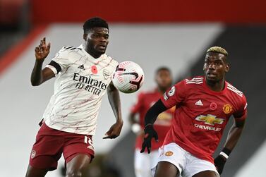 Soccer Football - Premier League - Manchester United v Arsenal - Old Trafford, Manchester, Britain - November 1, 2020 Manchester United's Paul Pogba in action with Arsenal's Thomas Partey Pool via REUTERS/Shaun Botterill EDITORIAL USE ONLY. No use with unauthorized audio, video, data, fixture lists, club/league logos or 'live' services. Online in-match use limited to 75 images, no video emulation. No use in betting, games or single club /league/player publications. Please contact your account representative for further details.