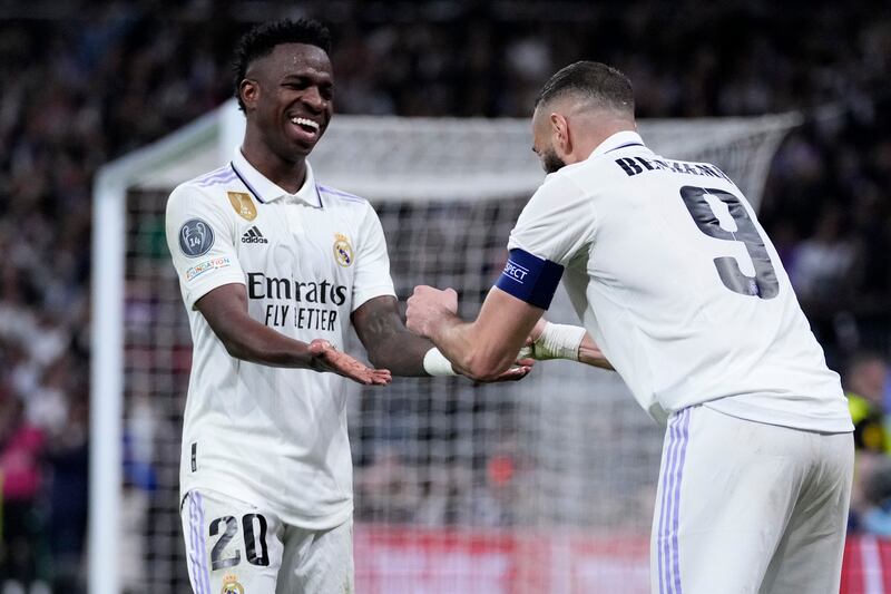 Karim Benzema celebrates with Vinicius Junior after scoring. AP