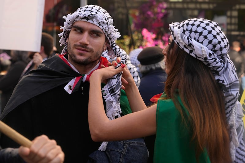 Two people wear Palestinian keffiyehs, during a Pro-Palestinian demonstration march in Madrid, Spain. AP