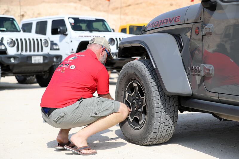 Mechanics make sure the cars have the correct tyre pressure to cope with the desert conditions