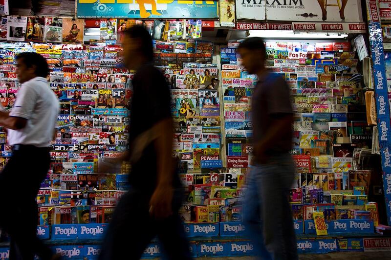 Shoppers walk past a newsstand that sells Indian and Indian versions of international magazines in Khan market in New Delhi on 18 September 2008. Photo : Suzanne Lee for The National.