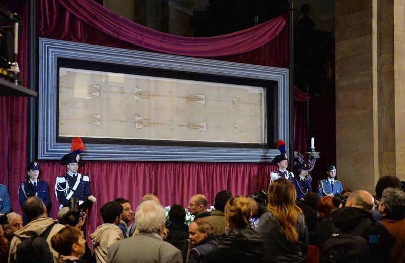 People look at the Holy Shroud of Turin during a press preview at the Cathedral of Turin, in Turin, Italy, on April 18, 2015. Alessandro Di Marco/EPA