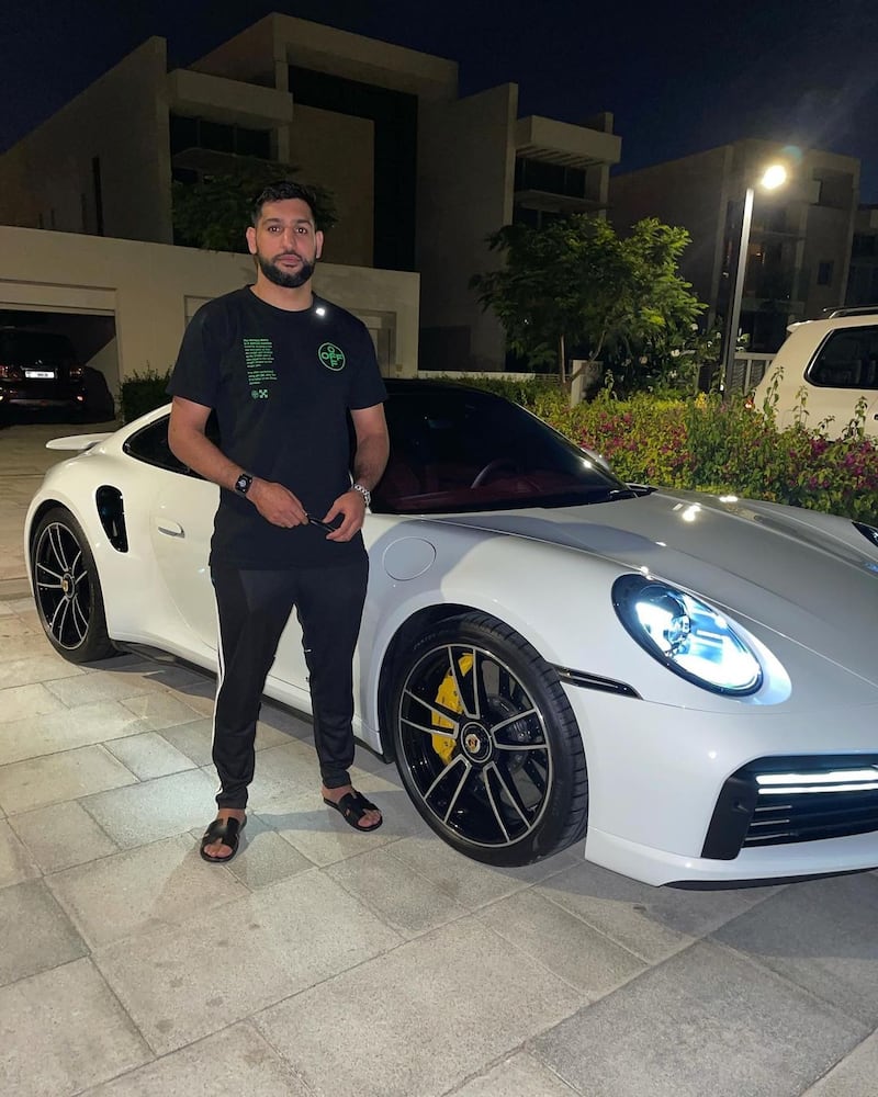 Amir Khan poses with his Porsche 911 in Dubai's District One, Mohammed Bin Rashid City, in April 2021. Instagram / Amir Khan