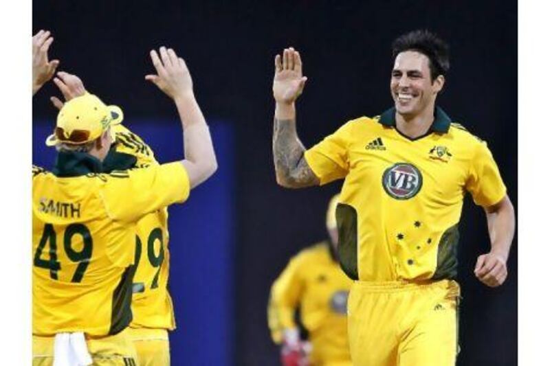 Mitchell Johnson celebrates with his teammates after the dismissal of Suraj Randiv in Kandy, Sri Lanka.