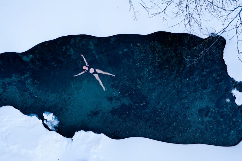 An aerial view of a woman bathing in an icy lake near Yuzhno-Sakhalinsk on Sakhalin Island in Russia's Far East. Some Russians observe the Orthodox Christian feast day of Epiphany by immersing in freezing water through holes cut through the ice of lakes and rivers. AP Photo