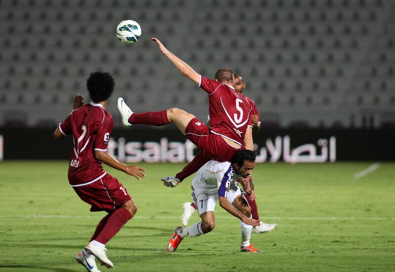 AL AIN , UNITED ARAB EMIRATES Ð Oct 14 : Srdan Andric ( no 5 in maroon ) of Al Wahda and Ali Al Wehaibi ( no 7 in white ) of Al Ain in action during the Etisalat Cup round 3 football match between Al Wahda vs Al Ain at Tahnoun Bin Mohammed Stadium in Al Ain. ( Pawan Singh / The National ) For Sports. Story by Amit