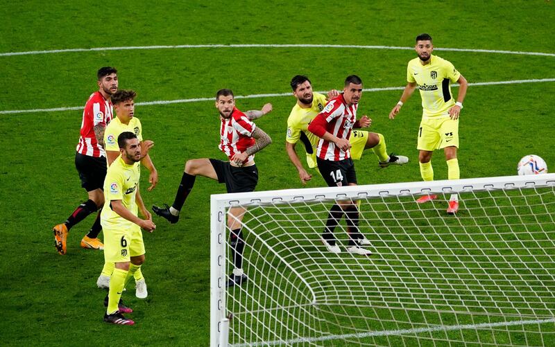 Athletic Bilbao's Inigo Martinez scores their second goal against Atletico Madrid. Reuters