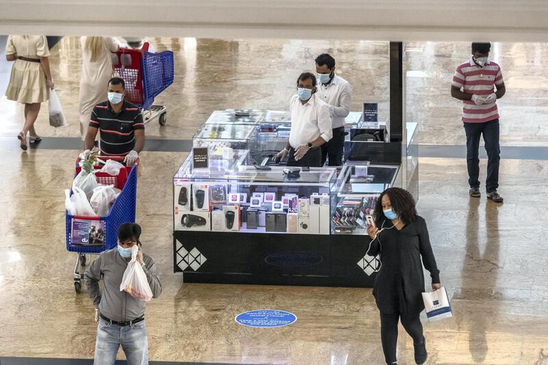 DUBAI, UNITED ARAB EMIRATES. 24 MAY 2020. The first day of the Eid holidays saw shoppers head to Mall of the Emirates to shop for both food and luxury items. Mall staff have put in place thermal scanning at entry ways and shops are supplying hand santizer and in some cases glothes when shoppers enter the stores. Social distancing is also being observed for the most part as restrictions are in place by Dubai Government. (Photo: Antonie Robertson/The National) Journalist: Kelly Clarke. Section: National.