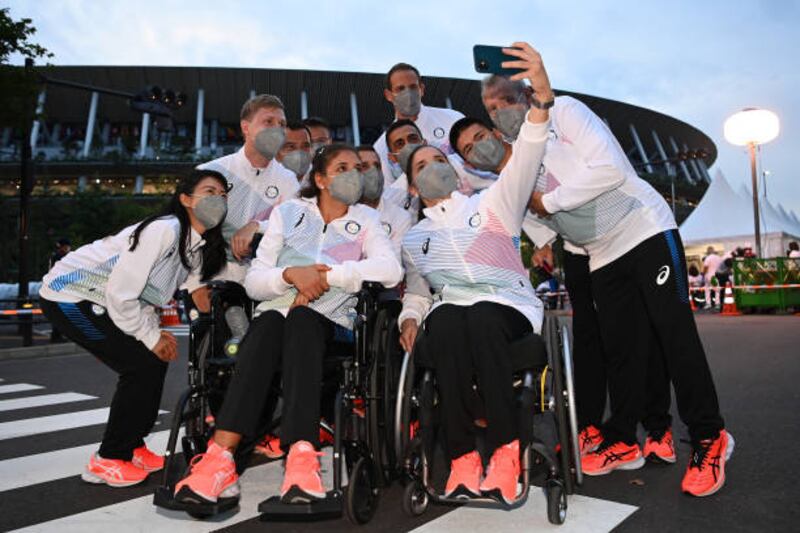 Chef de Mission of Refugee Paralympic Team Ileana Rodriguez takes a selfie during their arrival at the opening ceremony of the Tokyo 2020 Paralympic Games. Getty