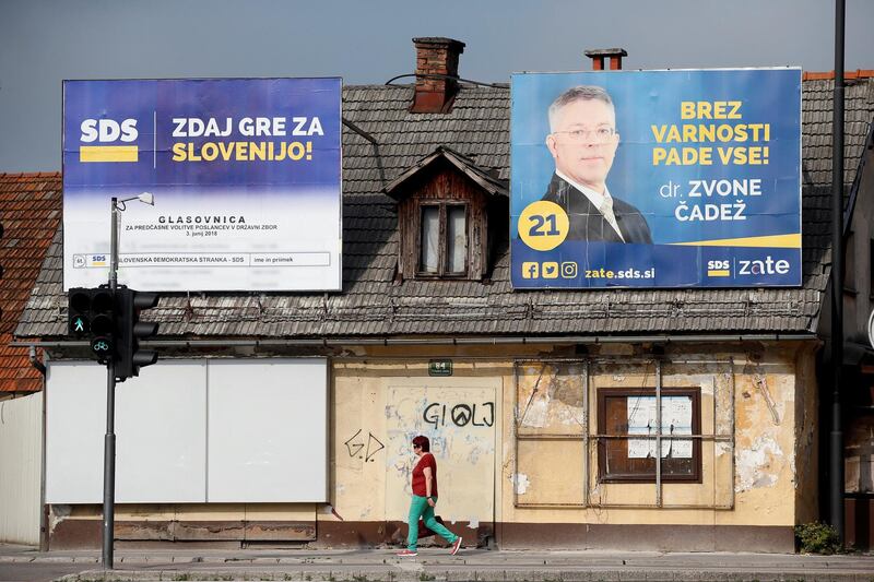 REFILE - CORRECTING PARTY NAME A woman walks under election posters of the Slovenian Democratic Party (SDS) for general elections in Ljubljana, Slovenia, May 31, 2018. REUTERS/Borut Zivulovic