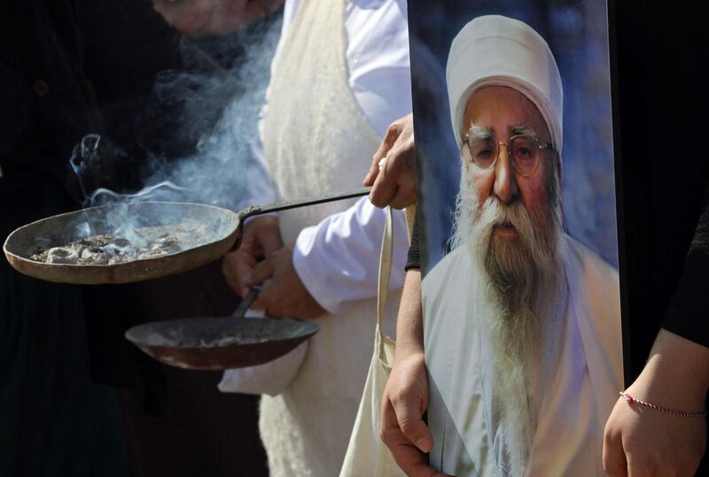 Iraqi Yazidis burn incense during the funeral of Baba Sheikh Khurto Hajji Ismail. AFP