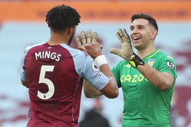 Aston Villa's Argentinian goalkeeper Emiliano Martinez (R) celebrates with Aston Villa's English defender Tyrone Mings (L) at the end of the English Premier League football match between Aston Villa and Arsenal at Villa Park in Birmingham, central England on February 6, 2021. RESTRICTED TO EDITORIAL USE. No use with unauthorized audio, video, data, fixture lists, club/league logos or 'live' services. Online in-match use limited to 120 images. An additional 40 images may be used in extra time. No video emulation. Social media in-match use limited to 120 images. An additional 40 images may be used in extra time. No use in betting publications, games or single club/league/player publications. / AFP / POOL / Nick Potts / RESTRICTED TO EDITORIAL USE. No use with unauthorized audio, video, data, fixture lists, club/league logos or 'live' services. Online in-match use limited to 120 images. An additional 40 images may be used in extra time. No video emulation. Social media in-match use limited to 120 images. An additional 40 images may be used in extra time. No use in betting publications, games or single club/league/player publications.