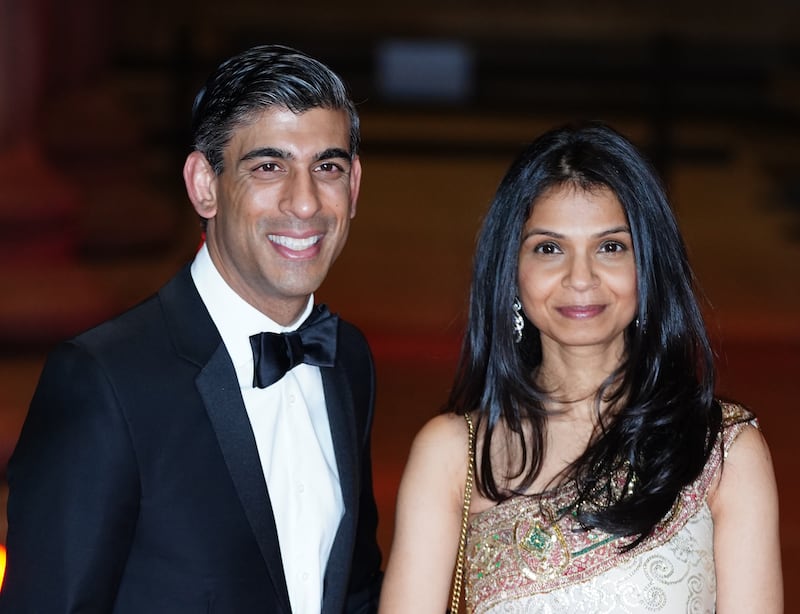 File photo dated 09/02/22 of Chancellor of the Exchequer Rishi Sunak alongside his wife Akshata Murty, as the Chancellor's family has been accused of "sheltering" itself from paying tax in the UK after it emerged his wife holds non-domiciled status. PA