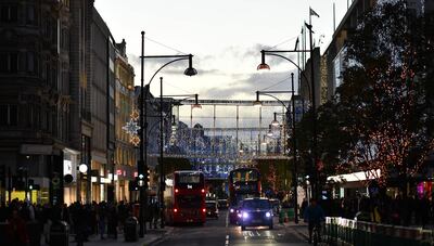 The Christmas lights illuminate the main shopping Oxford Street in central London on November 2, 2020.  British Prime Minister Boris Johnson on Monday defended his belated decision to impose a second coronavirus lockdown as critics claimed he could have saved "thousands" of lives by acting sooner. / AFP / Ben STANSALL
