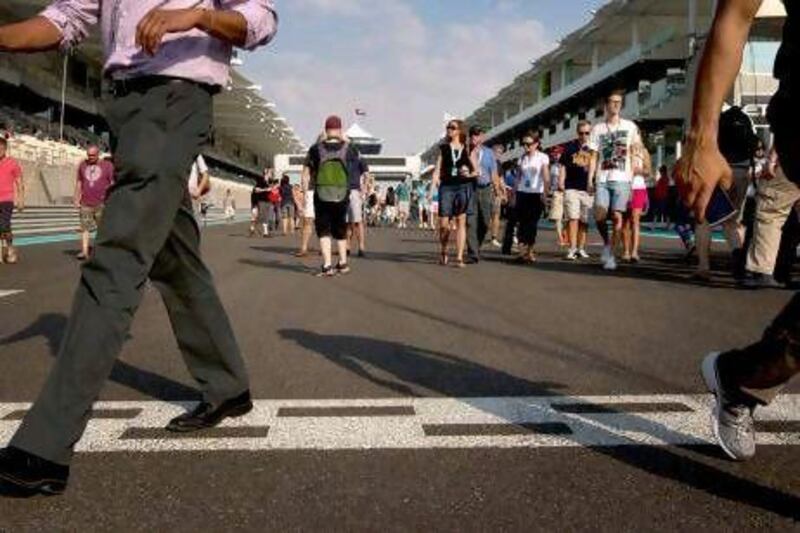 Fans take part in the pit walk day at the Yas Marina Circuit.