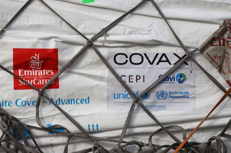 An Emirates logo is seen next to a Covax tag on a batch of Covid-19 vaccines at Kotoka International Airport in Accra, Ghana. AFP