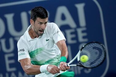 Serbia's Novak Djokovic returns the ball to Russia's Karen Khachanov during a match at the Dubai Duty Free Tennis Championship in Dubai, United Arab Emirates, Wednesday, Feb.  23, 2022.  (AP Photo / Ebrahim Noroozi)