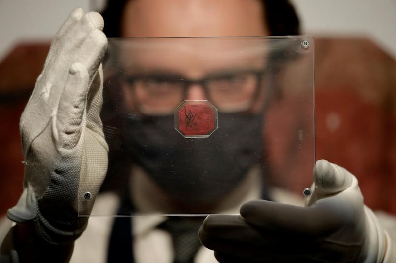 A British Guiana One-Cent Magenta stamp, estimated to be worth $20 million, is displayed for photographs at  the premises of Sotheby's auction house in London. AP