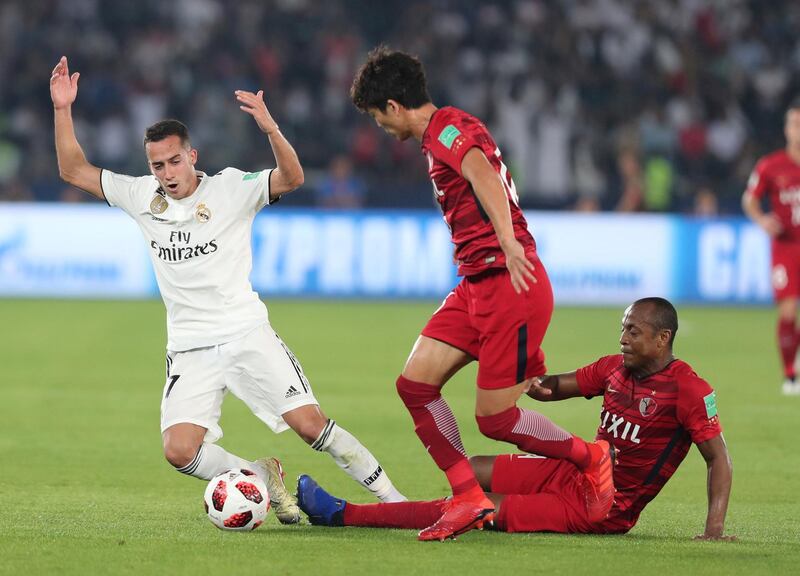 Abu Dhabi, United Arab Emirates - December 19, 2018: Real Madrid's Lucas Vazquez is tackled by Antlers' Hugo Leonardo (R) during the game between Real Madrid and Kashima Antlers in the Fifa Club World Cup semi final. Wednesday the 19th of December 2018 at the Zayed Sports City Stadium, Abu Dhabi. Chris Whiteoak / The National