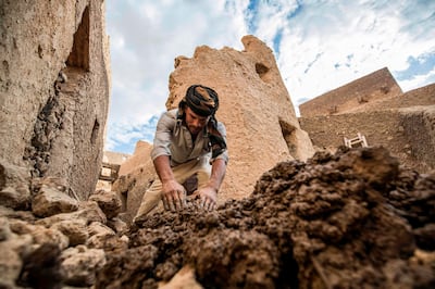 An Egyptian labouror works on the restoration of the fortress of Shali, in the Egyptian desert oasis of Siwa, some 600 kms southwest of the capital Cairo, on November 5, 2020.  The 13th century edifice, called Shali or "Home" in the Siwi language, was built by Berber populations, using kershef, a mixture of clay, salt and rock which acts as a natural insulator in an area where the summer heat can be scorching.
After it was worn away by erosion, and then torrential rains in 1926, the European Union and Egyptian company Environmental Quality International (EQI) from 2018 sought to restore the building, at a cost of over $600,000.
 / AFP / Khaled DESOUKI
