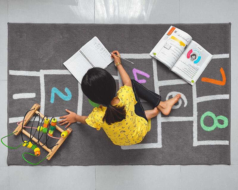 'Taking advantage of time' by Saqr Al Hueishl from Riyadh, Saudi Arabia. This was taken of the photographer's daughter, studying and trying to recap what she missed out on during quarantine