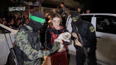 A woman and her dog who were taken hostage by Hamas are handed over to the International Committee of the Red Cross as part of a hostage-prisoner swap deal in November. Reuters