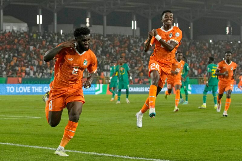 Franck Kessie, left, equalised from the penalty spot to send the game against Senegal to extra time then scored the decisive spot kick to seal victory for Ivory Coast. AP